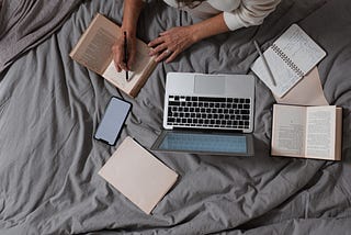 A person writing on a book.