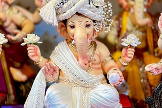 A breathtaking white Ganesh idol, symbolizing purity and serenity, intricately crafted with delicate details, capturing the divine essence of Ganesh Chaturthi 2024.