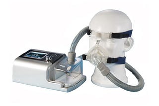 “BiPAP machine setup demonstrated on a medical mannequin. The device sits beside the mannequin, with tubes connecting to a face mask fitted over the dummy’s nose and mouth.” Bipap machine On rent