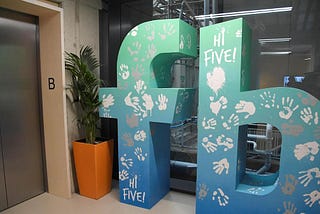 Stylalised ‘fb’  Facebook logo by the lifts in the Facebook office in London.