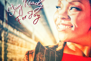 Image of African-American woman (Sonya Denyse) smiling with her face to the sun, with the words “stay ready for joy”