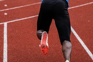 A professional sprinter in onward movement — Photo by Nicolas Hoizey on Unsplash