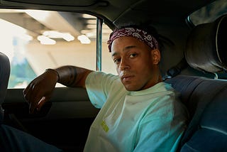 teenager in backseat of car