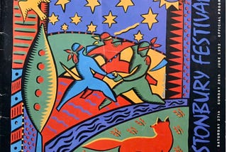 Photograph of programme for 1992 Glastonbury Festival. Includes an illustration of three people dancing in a field, being watched by a fox.