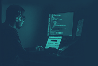 developer writing code in a dark room