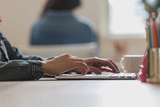 woman typing on a laptop