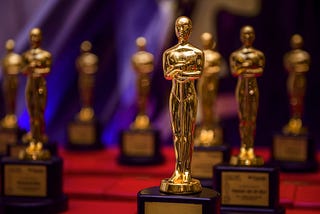 Oscar statues on a red carpet