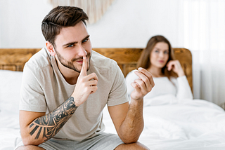 Handsome man shows sign of silence