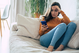 Frustrated upset women looking at her phone