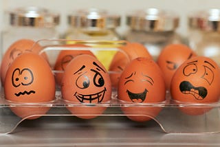 Marketing psychology image showing 8 eggs with face drawn on them.