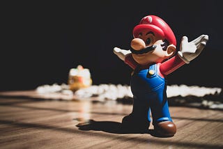 A Super Mario figurine raising its arms.