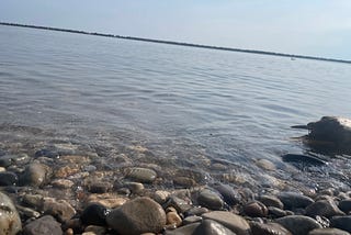 picture of a lake and lakefront with pebbles on it