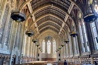 A large library hall in a gothic style architecture.