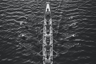 Team rowing together towards an aligned direction