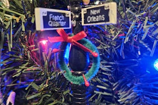 Christmas decoration of an old fashioned light post, with French Quarter and New Orleans written on the signs.