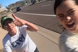 Two women running, one giving the thumbs up