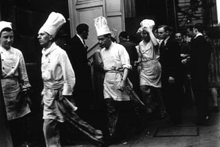 Chefs walk out of the Ritz hotel in London to hear an address by Arthur Lewis MP after which they went on strike.