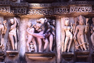 Sculptures in Lakshmana Temple showing gods and a couple practicing maithuna sex.