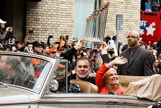 San Francisco Giant manager at the time Bruce Bochy, now with the Texas Rangers, hoists the World Series trophy.