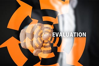 A finger pointing at the word evaluation surrounded by arrows arranged in a circle.