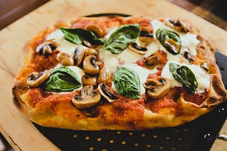 Pinsa on a pizza peel