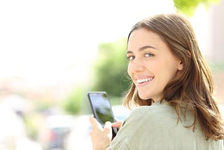 student with phone, smiling