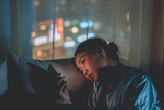 A woman sitting on a sofa using her phone