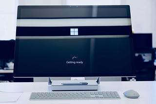 A monitor displays the load screen logo of windows 10.
