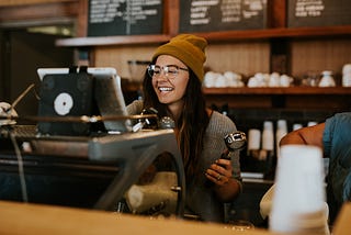 Happy girl working in a coffee shop.