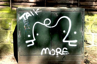Street art, local to Leeds, which features the words: talk more.