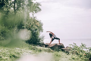 Photograph of a woman practicing yoga outdoors