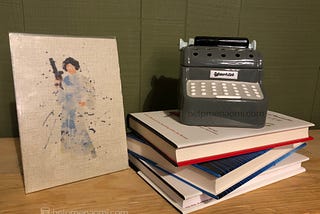 Princess Leia Burlap painting next to a stack of books with a miniature typewriter on top