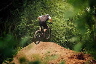 A man on a bike hitting a jump.