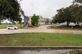 Business wall destroyed by tornado, torn down to metal framework.