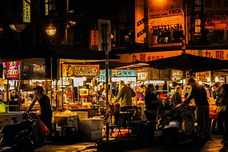 People eating street food at Ningxia Night Market in Taiwan