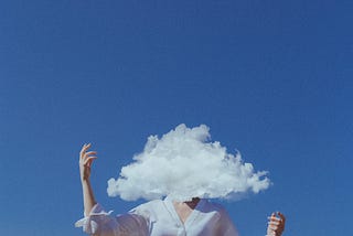 woman with face obscured y a cloud