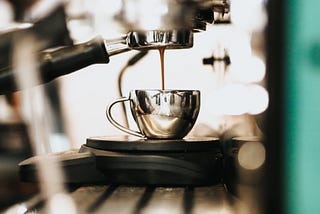 Shot of espresso being poured. Espresso machine.