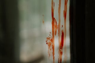 Blood streaking down a window