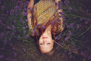 a girl sleeping in the field of flowers