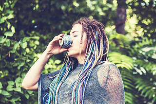Girl drinking a cup of Ayahuasca