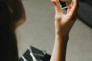 Woman looking into broken mirror