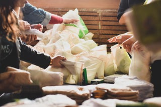 Assembling bags of menstrual products.