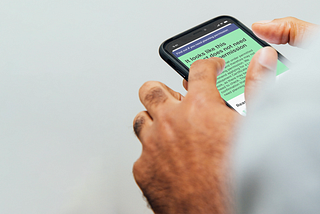 Someone is holding a smart phone, using a digital service. On the screen you can see the words ‘It looks like this project does not need planning permission’. It’s part of a service called ‘Find out if you need planning permission’.
