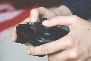 Guy playing video games holding an xbox controller