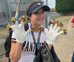 Woman at softball game with white gloves.