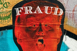 A picture of Donald Trump with “Fraud” written across his forehead