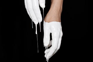 hands drenched in white paint