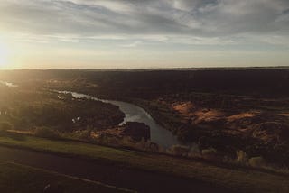 Sunset overlooking a river within a canyon.