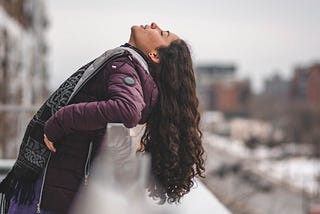 woman leaning back and looking at the sky