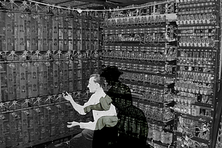 A black-and-white image depicting the early computer, Bombe Machine, during World War II. In the foreground, the shadow of a woman in vintage clothing is cast on a man changing the machine’s cable.